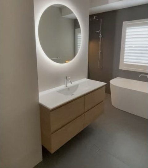 Bathroom with backlit mirror