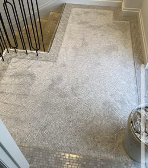 Mosaic floor at the top of a stair